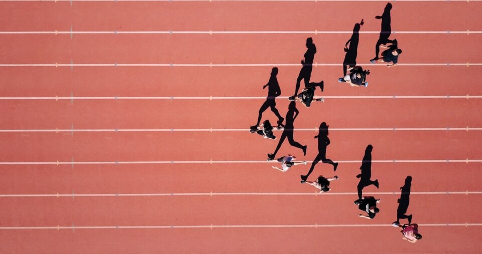 Athlete training on a track illustrating vigorous exercise benefits with a heart rate line and stopwatch