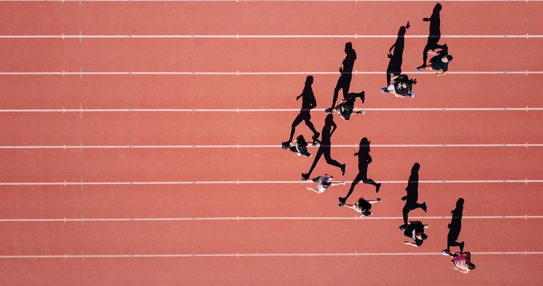 Athlete training on a track illustrating vigorous exercise benefits with a heart rate line and stopwatch